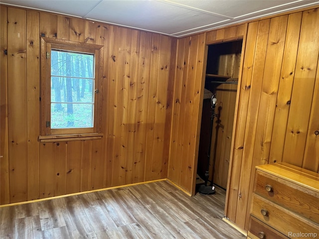 478 Karcher Rd, Rose City, MI 48654 - unfurnished bedroom featuring wood finished floors and wooden walls