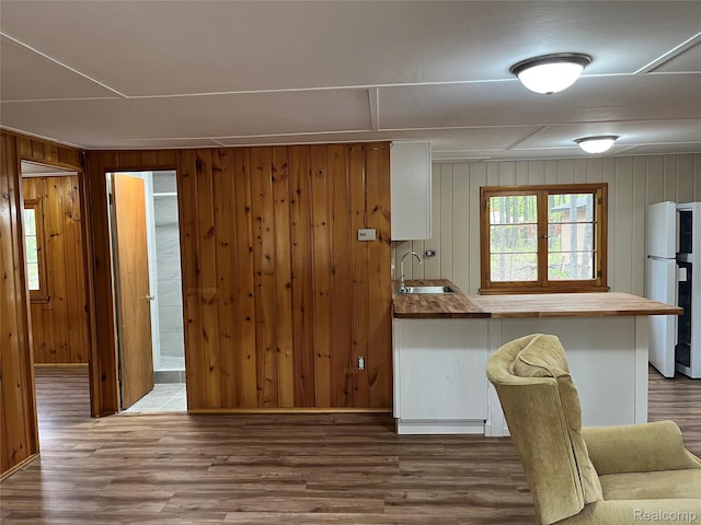 478 Karcher Rd, Rose City, MI 48654 - kitchen with freestanding refrigerator, a sink, butcher block counters, wood walls, and wood finished floors
