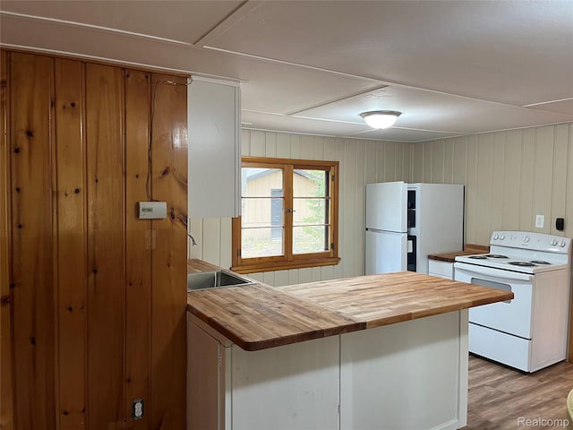 478 Karcher Rd, Rose City, MI 48654 - kitchen with white appliances, butcher block countertops, a sink, a peninsula, and wooden walls