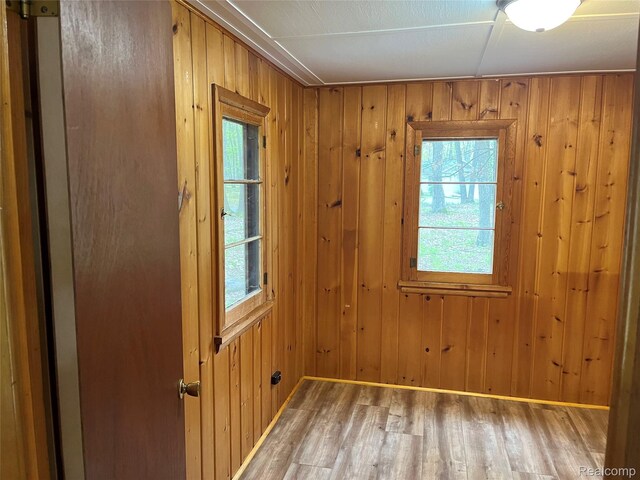 478 Karcher Rd, Rose City, MI 48654 - empty room featuring wood finished floors, wood walls, and baseboards