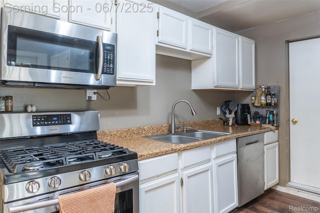 421 S Opdyke Rd, Auburn Hills, MI 48326 - kitchen featuring stainless steel appliances, a sink, white cabinets, dark wood-style floors, and light countertops
