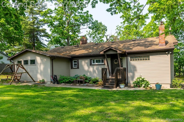 421 S Opdyke Rd, Auburn Hills, MI 48326 - rear view of property featuring a chimney, a yard, and a shingled roof
