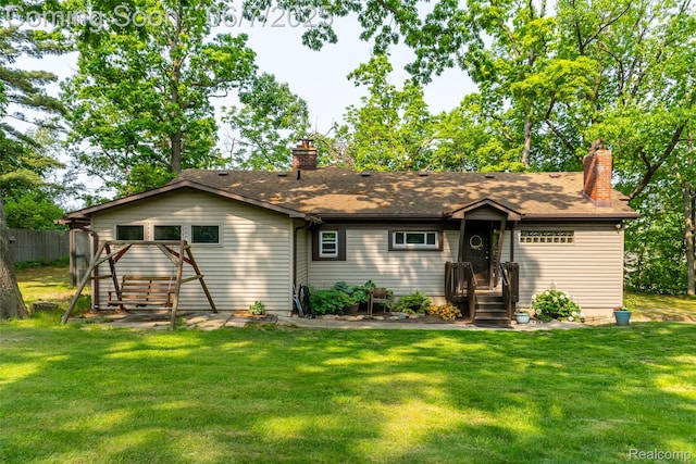 421 S Opdyke Rd, Auburn Hills, MI 48326 - rear view of property with a chimney, a lawn, and roof with shingles