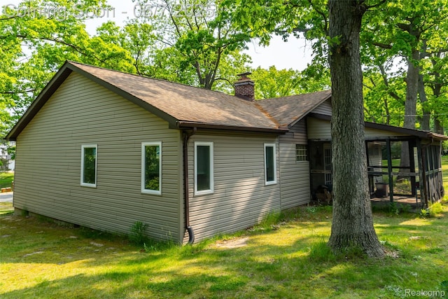 421 S Opdyke Rd, Auburn Hills, MI 48326 - view of property exterior featuring a chimney, a yard, a sunroom, and a shingled roof