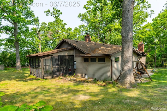421 S Opdyke Rd, Auburn Hills, MI 48326 - rear view of house with a chimney, a yard, a sunroom, and a shingled roof