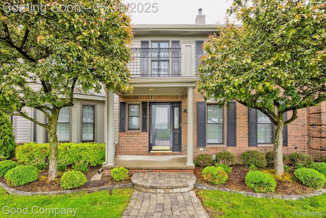 1660 Normandy Rd, Clawson, MI 48017 - view of exterior entry featuring a balcony, brick siding, and covered porch