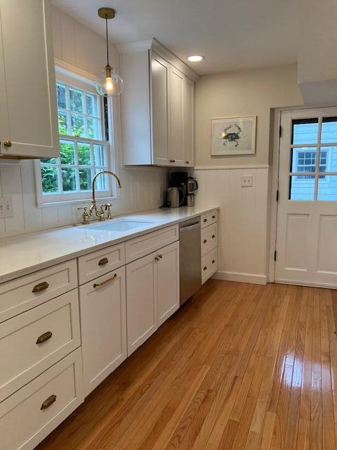 808 Princeton Ave, Ann Arbor, MI 48103 - kitchen with a sink, dishwasher, light wood-type flooring, and light countertops