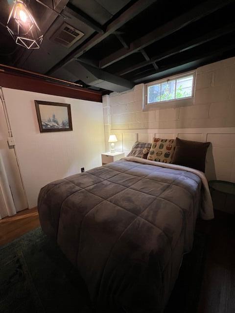 808 Princeton Ave, Ann Arbor, MI 48103 - bedroom with concrete block wall and wood finished floors