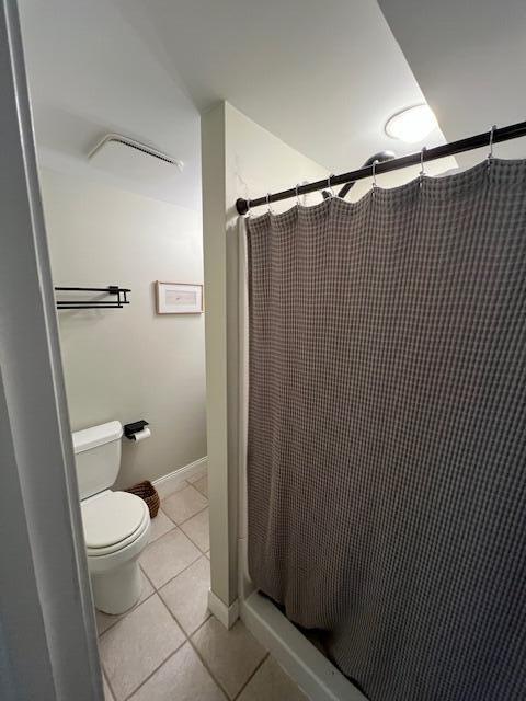 808 Princeton Ave, Ann Arbor, MI 48103 - bathroom with tile patterned flooring, a stall shower, and toilet