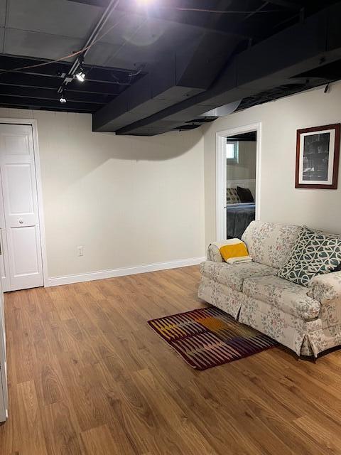 808 Princeton Ave, Ann Arbor, MI 48103 - finished below grade area with rail lighting, light wood-style flooring, and baseboards