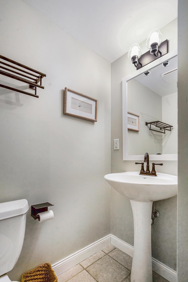 808 Princeton Ave, Ann Arbor, MI 48103 - half bath with baseboards, toilet, tile patterned flooring, and a sink