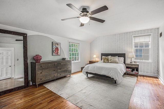 808 Princeton Ave, Ann Arbor, MI 48103 - bedroom featuring baseboards, wood-type flooring, wallpapered walls, lofted ceiling, and ceiling fan