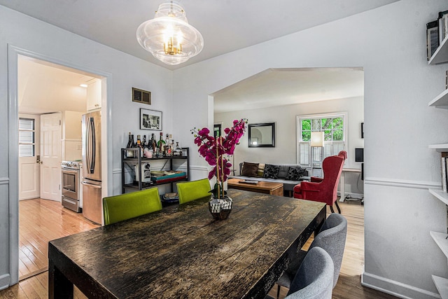 808 Princeton Ave, Ann Arbor, MI 48103 - dining room featuring wood finished floors, a chandelier, and baseboards