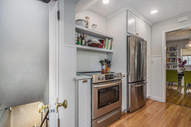 808 Princeton Ave, Ann Arbor, MI 48103 - kitchen with appliances with stainless steel finishes, light wood-style floors, white cabinets, light countertops, and recessed lighting