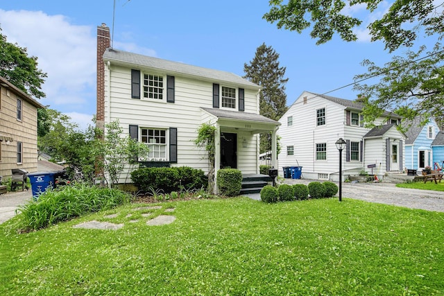 808 Princeton Ave, Ann Arbor, MI 48103 - view of front facade with a chimney, a front yard, and driveway