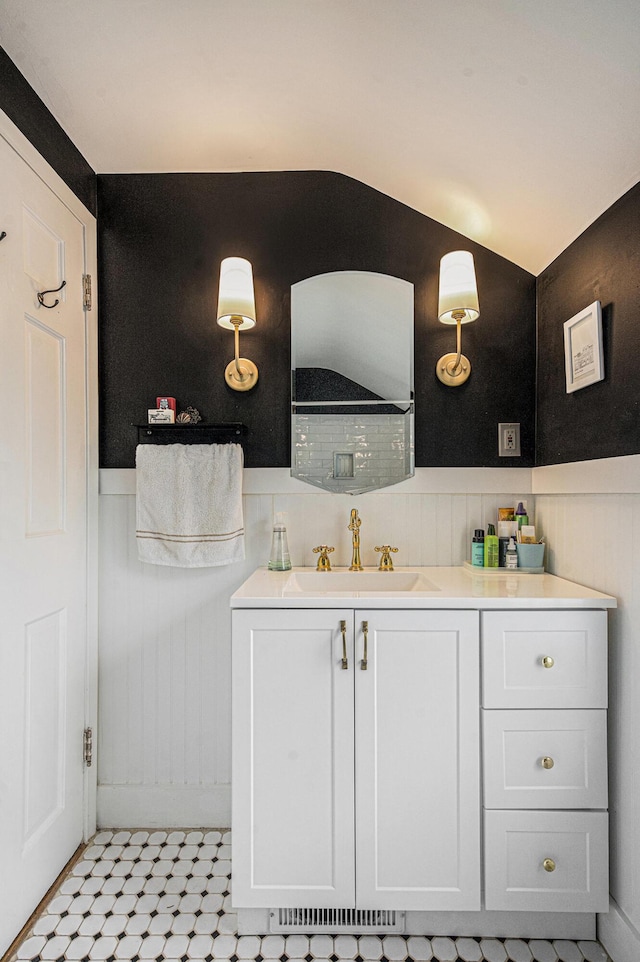 808 Princeton Ave, Ann Arbor, MI 48103 - bathroom with wainscoting, vanity, and vaulted ceiling