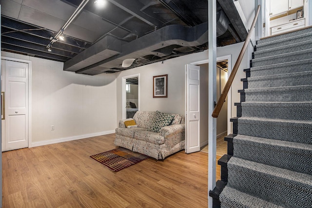808 Princeton Ave, Ann Arbor, MI 48103 - finished basement with rail lighting, stairway, baseboards, and light wood finished floors