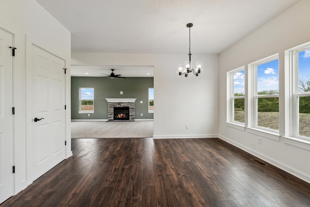 705 Montels Way, Charlotte, MI 48813 - unfurnished living room featuring dark wood-type flooring, plenty of natural light, and a ceiling fan
