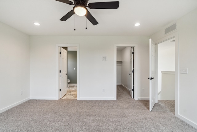 705 Montels Way, Charlotte, MI 48813 - unfurnished bedroom featuring light colored carpet, a walk in closet, baseboards, recessed lighting, and ceiling fan