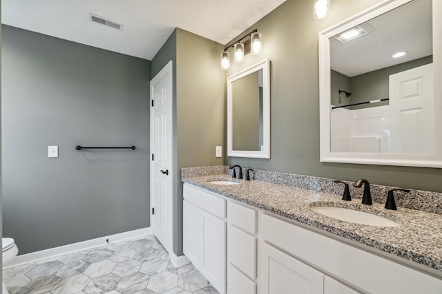705 Montels Way, Charlotte, MI 48813 - full bath featuring double vanity, toilet, baseboards, and a shower