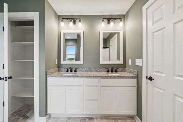 705 Montels Way, Charlotte, MI 48813 - full bath featuring marble finish floors, double vanity, and a closet