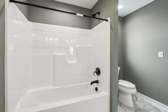 705 Montels Way, Charlotte, MI 48813 - bathroom with baseboards, toilet, marble look tiles, and shower / washtub combination