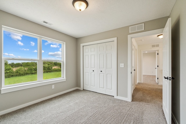 705 Montels Way, Charlotte, MI 48813 - unfurnished bedroom featuring carpet floors, a closet, and baseboards