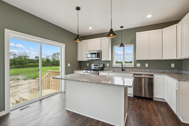 705 Montels Way, Charlotte, MI 48813 - kitchen with stainless steel appliances, a sink, healthy amount of natural light, white cabinets, and recessed lighting