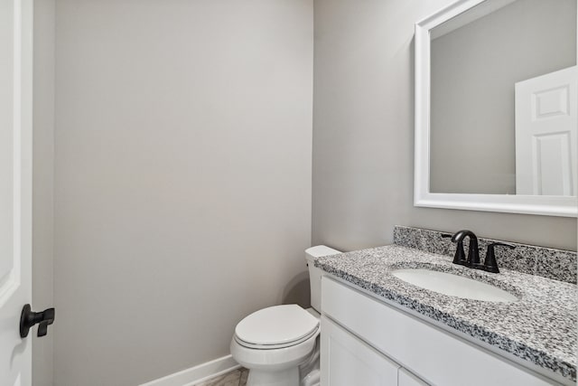 705 Montels Way, Charlotte, MI 48813 - bathroom with vanity, toilet, and baseboards