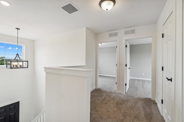 705 Montels Way, Charlotte, MI 48813 - hall with an upstairs landing, carpet floors, a chandelier, and baseboards