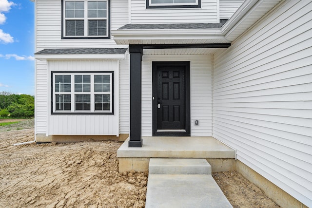 705 Montels Way, Charlotte, MI 48813 - view of exterior entry with a shingled roof