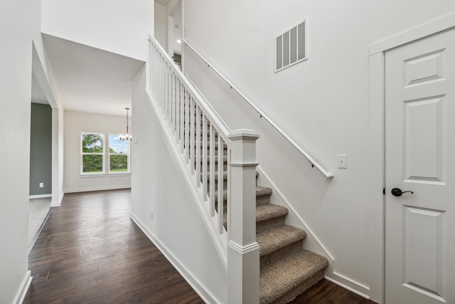 705 Montels Way, Charlotte, MI 48813 - stairway with a chandelier, wood finished floors, and baseboards