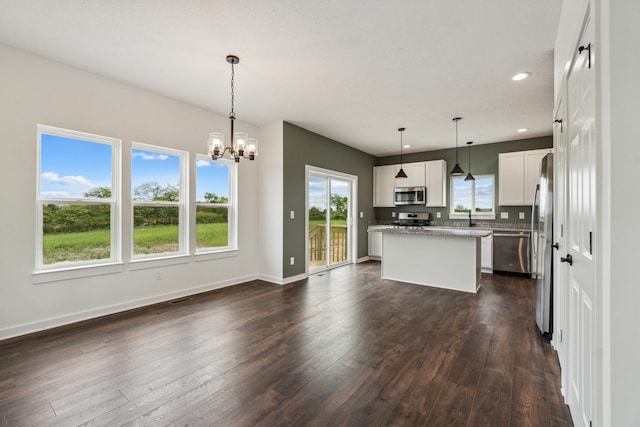 705 Montels Way, Charlotte, MI 48813 - kitchen featuring appliances with stainless steel finishes, a center island, dark wood-style flooring, baseboards, and recessed lighting