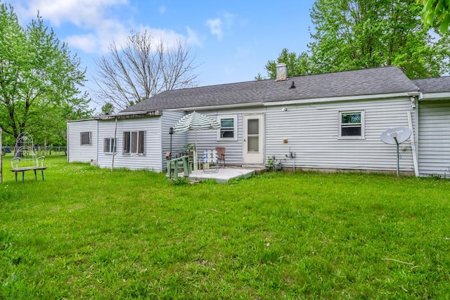 75 Taylor Ave, Battle Creek, MI 49037 - rear view of property featuring a patio area, a lawn, and a chimney