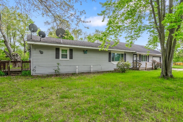 75 Taylor Ave, Battle Creek, MI 49037 - back of house featuring a lawn and a garage