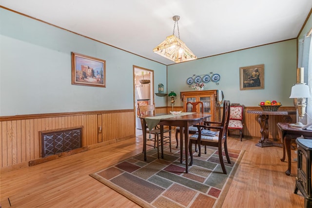 75 Taylor Ave, Battle Creek, MI 49037 - dining space with wood finished floors, a wainscoted wall, and ornamental molding