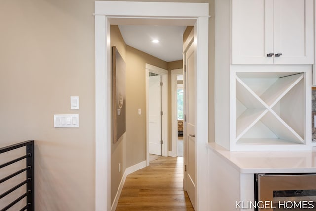 127 Emmet St, Grand Haven, MI 49417 - hall with light wood-style flooring, baseboards, and beverage cooler