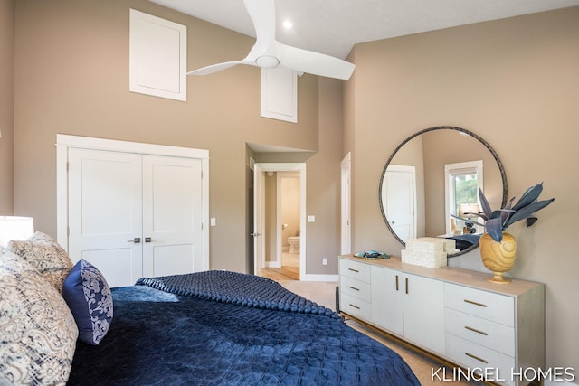 127 Emmet St, Grand Haven, MI 49417 - bedroom with a high ceiling, baseboards, and light carpet