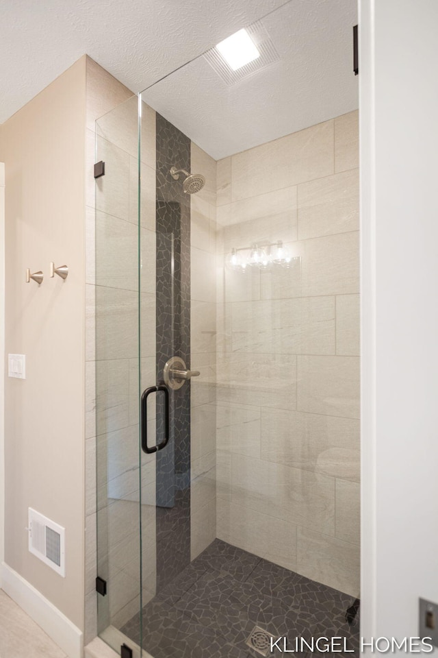 127 Emmet St, Grand Haven, MI 49417 - bathroom featuring a stall shower and a textured ceiling