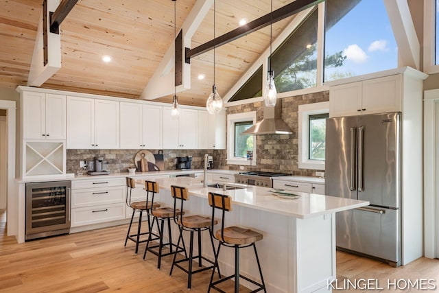 127 Emmet St, Grand Haven, MI 49417 - kitchen featuring high end fridge, beverage cooler, wooden ceiling with exposed beams, light wood-style floors, and light countertops