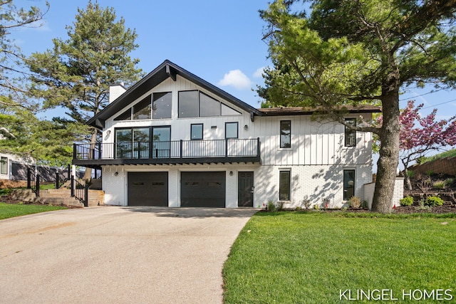 127 Emmet St, Grand Haven, MI 49417 - view of front of house with a chimney, concrete driveway, brick siding, a front lawn, and board and batten siding