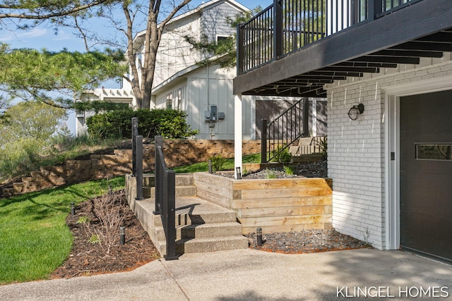 127 Emmet St, Grand Haven, MI 49417 - view of exterior entry featuring brick siding, a balcony, and a garage