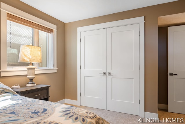 127 Emmet St, Grand Haven, MI 49417 - carpeted bedroom featuring a closet and baseboards