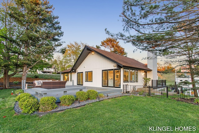 127 Emmet St, Grand Haven, MI 49417 - back of property with a chimney, a wooden deck, and an outdoor living space
