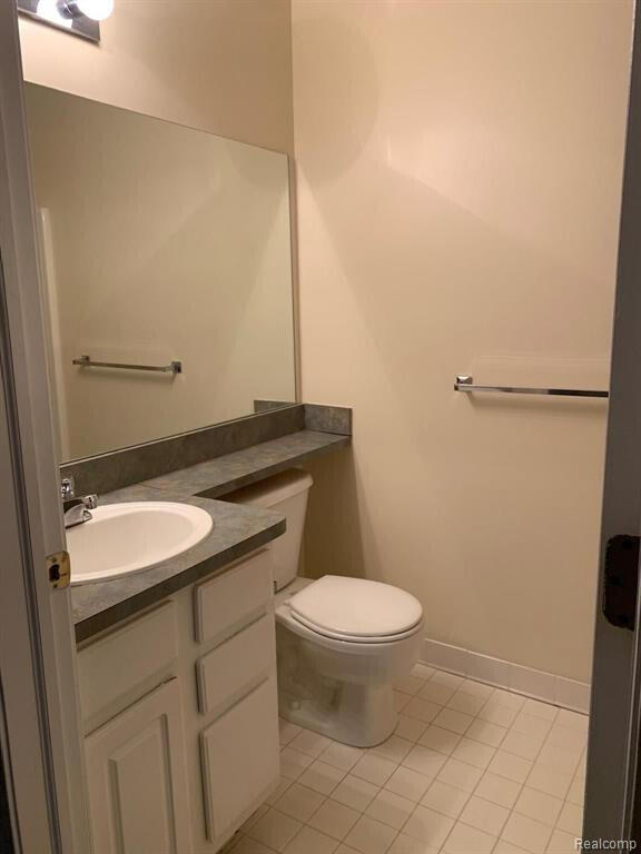 1240 University Dr Unit 2, Pontiac, MI 48342 - half bath with tile patterned floors, vanity, and toilet
