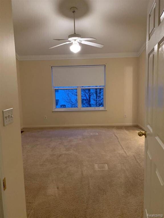 1240 University Dr Unit 2, Pontiac, MI 48342 - carpeted spare room with ceiling fan, baseboards, and crown molding
