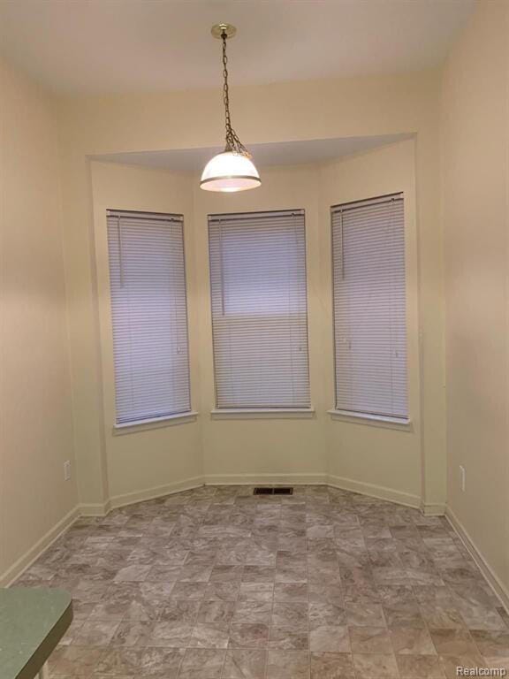 1240 University Dr Unit 2, Pontiac, MI 48342 - unfurnished dining area featuring baseboards