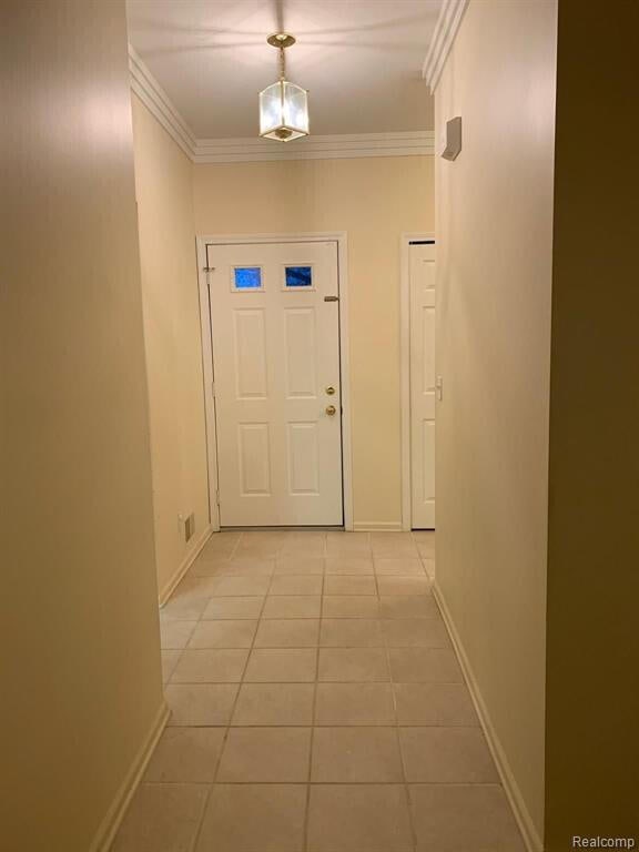 1240 University Dr Unit 2, Pontiac, MI 48342 - hallway with light tile patterned floors, baseboards, and ornamental molding