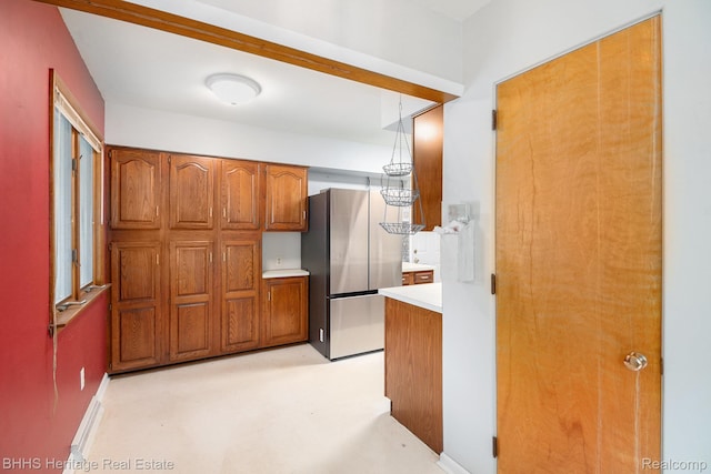 3226 Glasgow Dr, Lansing, MI 48911 - kitchen with freestanding refrigerator, brown cabinets, and light countertops