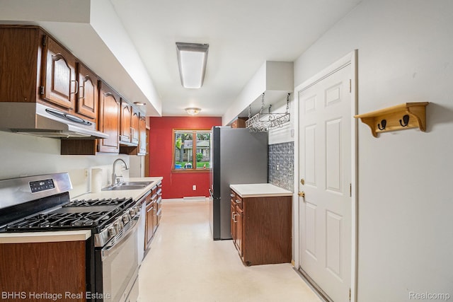 3226 Glasgow Dr, Lansing, MI 48911 - kitchen with stainless steel appliances, under cabinet range hood, a sink, and light countertops
